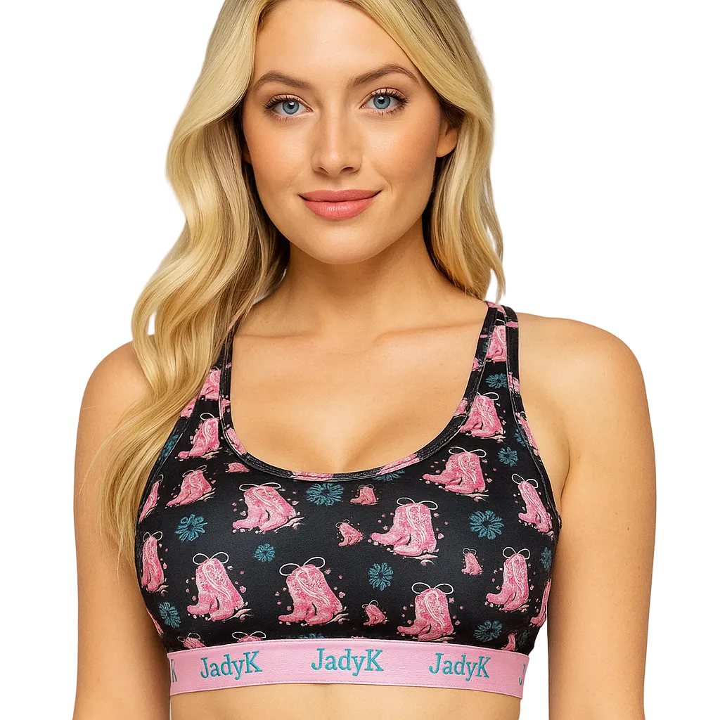 Woman wearing a black sports bra with pink patterns and 'JadyK' branding on a light gray background